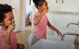 woman sitting in front of laptop smiling away