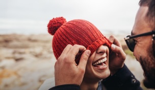 Woman smiling in backpack walking with friend in countryside
