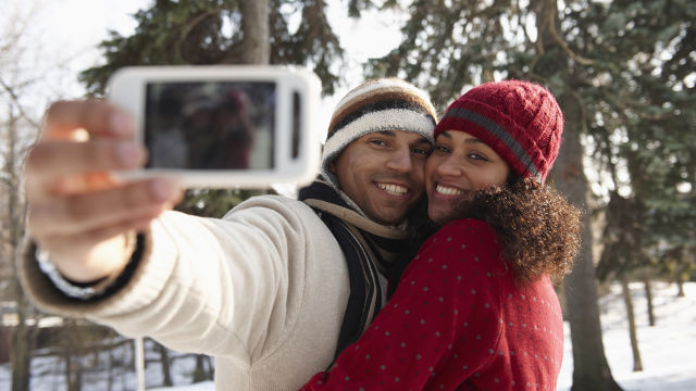 Couple posing for a photo, smiling and enjoying the moment.