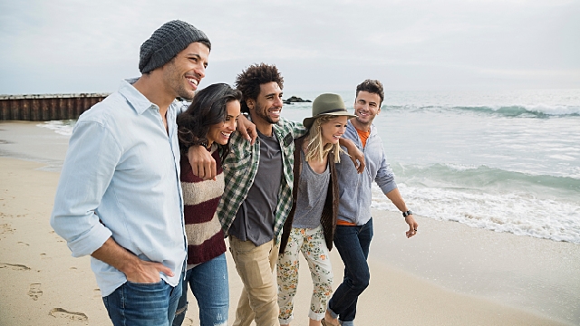 Friends walking on the beach
