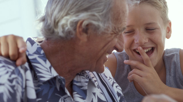 Grandfather and grandson laughing