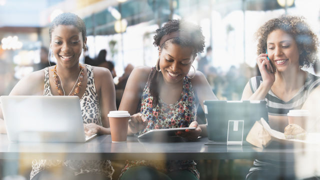 Friends drinking coffee and smiling