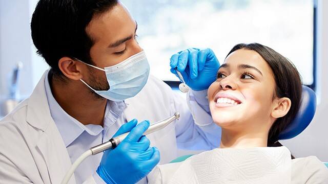 Dentist inspecting patient
